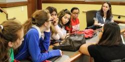 Image of students listening to a linguistics faculty member.