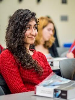 Student in red sweater sitting in classroom