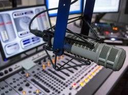 Photo of microphone in front of mixing board